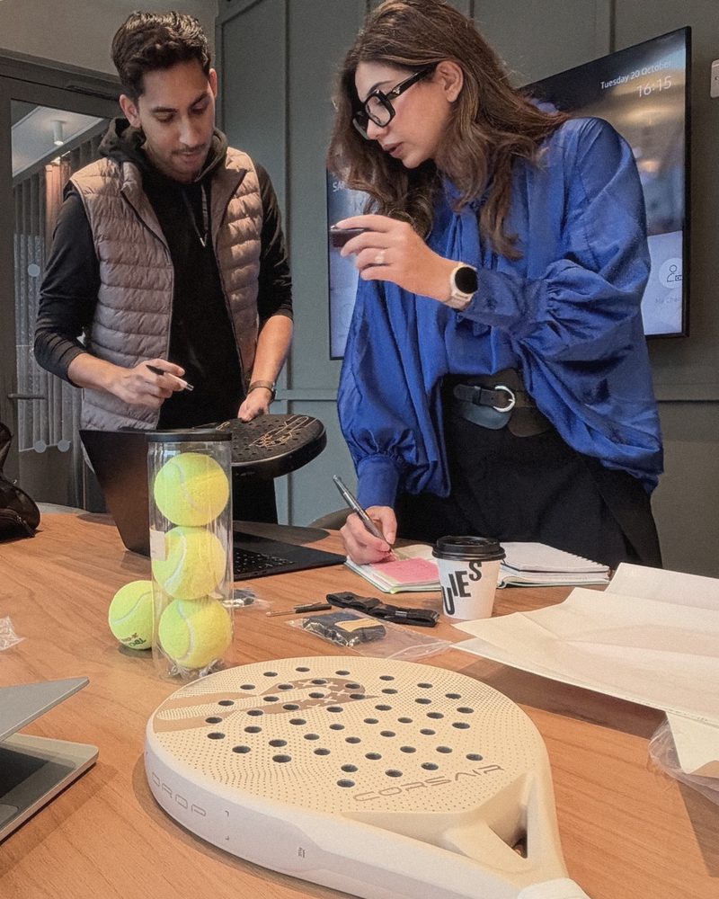 Two of the team reviewing samples at the table, DROP in the foreground